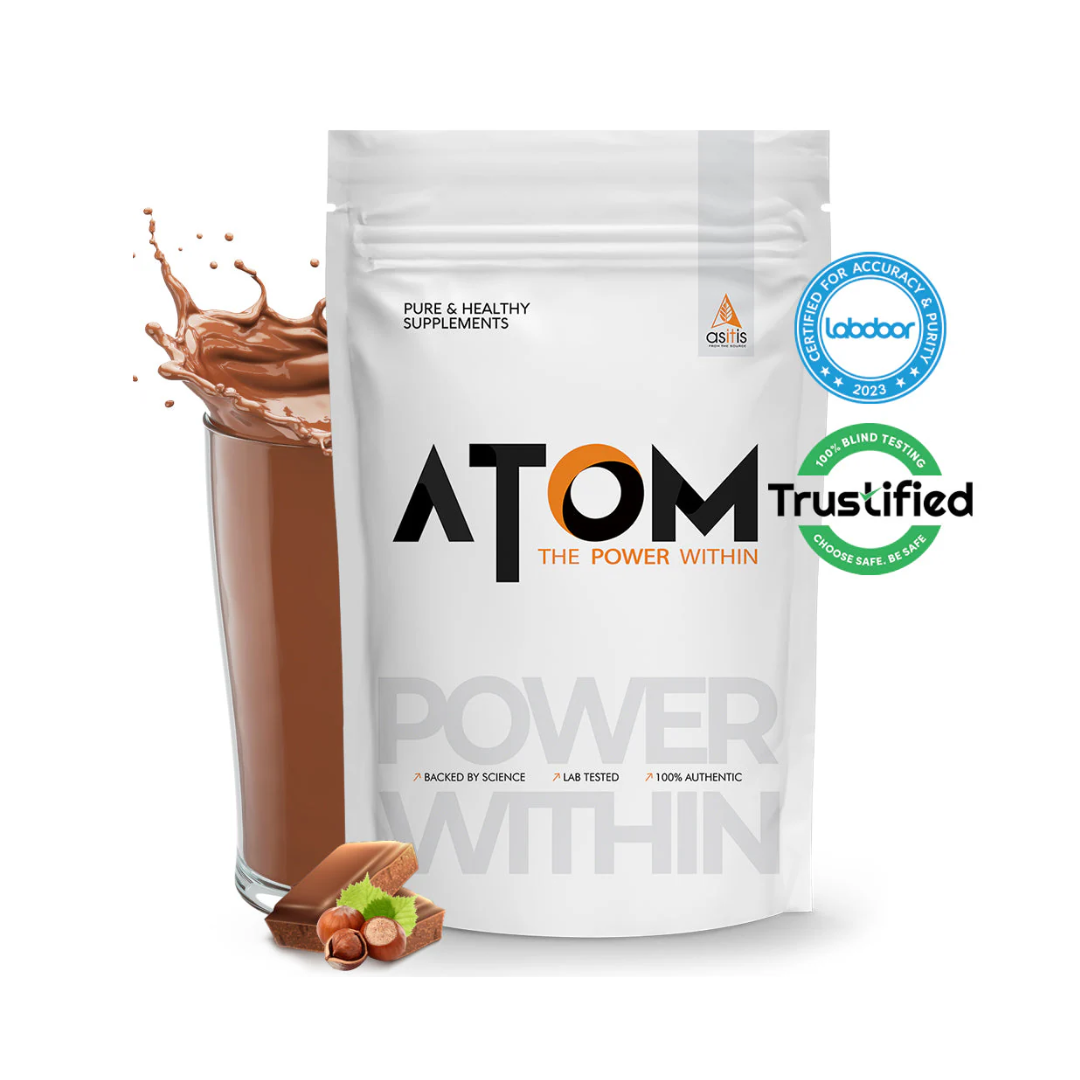 ATOM supplement package with a glass of chocolate drink and nuts on a white background
