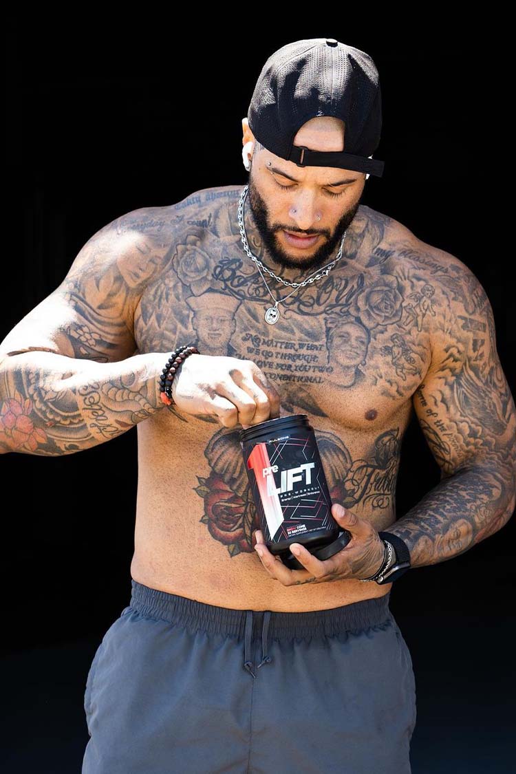 Man with tattoos holding a supplement container labeled 'UFT' against a black background