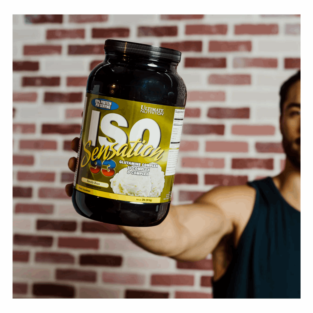 Person holding a supplement container labeled 'ISO Sensation' against a brick wall.